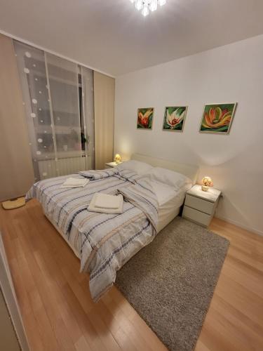 a bedroom with a large bed and two night stands at Apartman Jarun lake lux in Zagreb