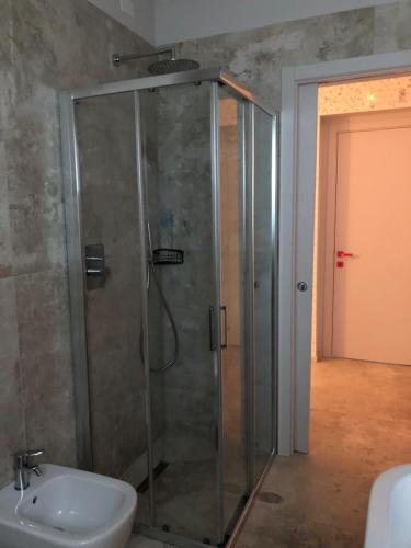 a bathroom with a shower and a toilet and a sink at La casa delle fragole in Marotta