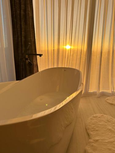 a bath tub in a bathroom with a window at Luxury Villa’s in Orllan