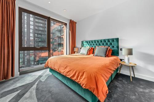a bedroom with a bed and a large window at CENTRAL LONDON STAY-Fabulous Ultra-Central London Luxury Designer One Bedroom Flat with inner garden view balcony AC and kitchen in London
