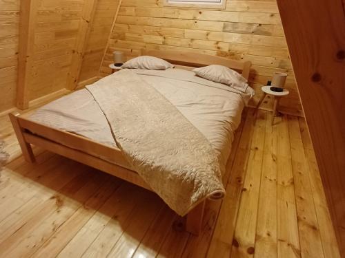 a bedroom with a bed in a wooden room at Mountain house Vojinovic Planinska kuća Vojinovic in Žabljak