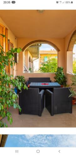 a picture of a patio with a table and chairs at El Giardino delle Rose..... in Serre di Rapolano