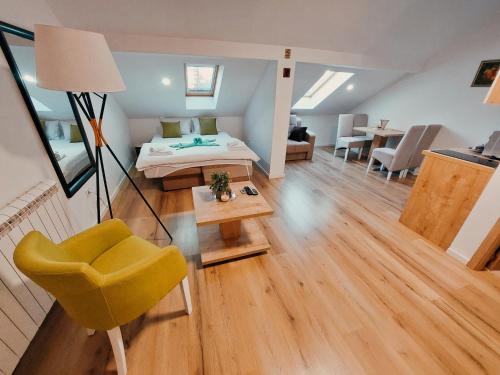 a room with a bed and a chair and a table at Buba Palace in Nikšić