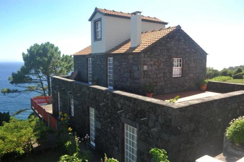 a house on top of a stone wall at Casa da Aguada in Lajes do Pico