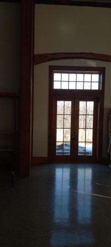 an empty room with a large door and windows at spacious former store 