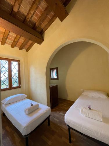 Postel nebo postele na pokoji v ubytování Casa vacanze Le due torri