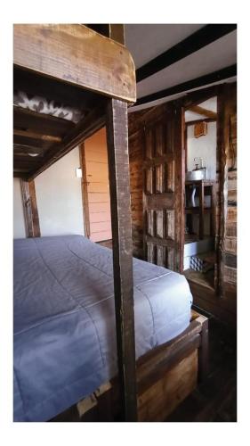 a bunk bed in a room with a wooden at Narakan Cabo Polonio in Cabo Polonio