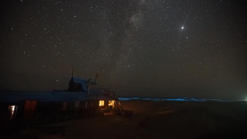 a boat in the sand under a starry sky at Narakan Cabo Polonio in Cabo Polonio