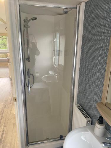 a bathroom with a shower and a sink at Nala Lodge in Knaresborough