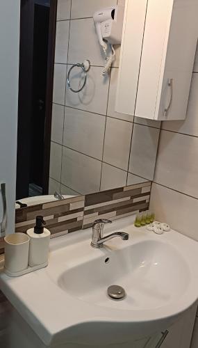 a bathroom with a sink and a mirror at Flory Holiday in Sibiu