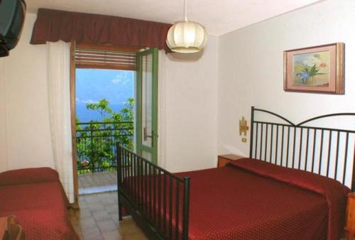 Postel nebo postele na pokoji v ubytování Hotel Augusta Garnì