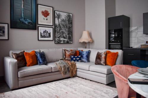 a living room with a couch with pillows on it at Duke Street Townhouse by EPIC in Liverpool
