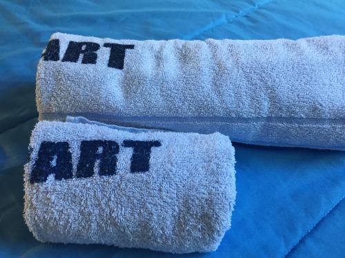 two towels with the word art written on them at Artistes du Monde in Montevideo