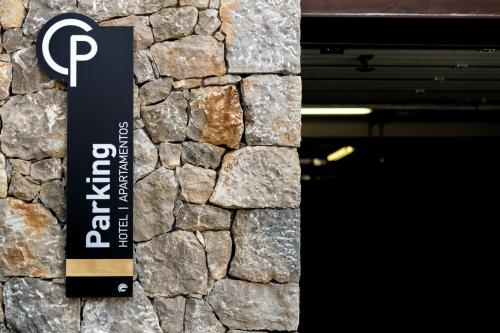 a sign on a stone wall next to a door at Tinas de Pechon in Pechón