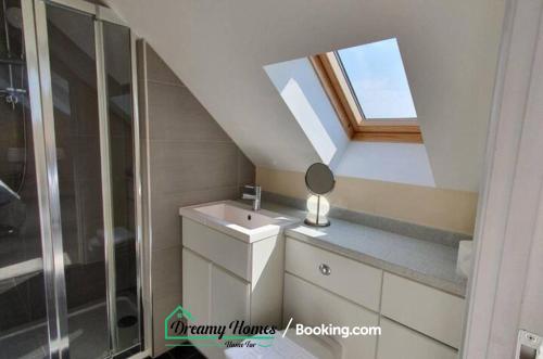 a bathroom with a sink and a skylight at Beach Braunton Spacious 3 Bed House By Dreamy Homes Short Lets & Serviced Accommodation Free Parking in Braunton