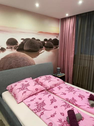 a bedroom with two beds with a pink blanket at Igényes Lakás in Szeged