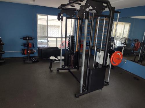 a room with a gym with several machines at Apartamento 3 Quartos - 807D in Contagem