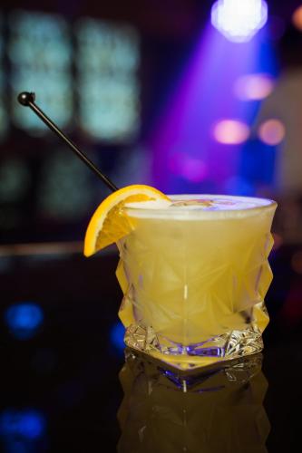 a drink with an orange slice on a bar at Hotel Majestic in Kolkata