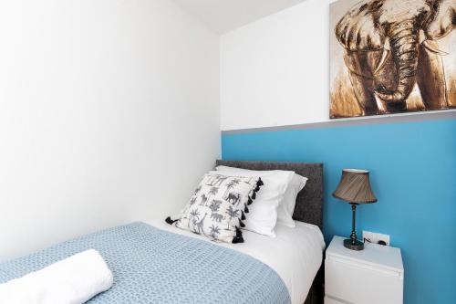 a bedroom with a bed and a painting on the wall at Ushaw House in Durham