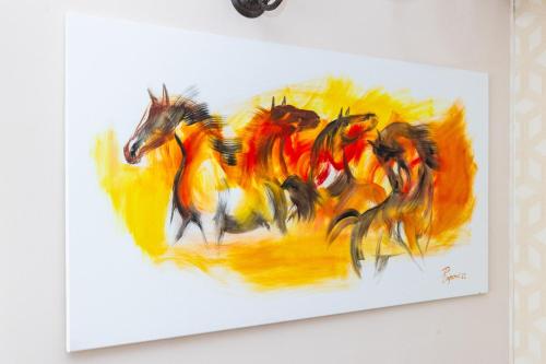 a painting of a group of horses running at VILA LUCA-Hotel in Şirnea