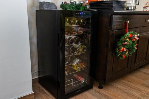 a black refrigerator with a rack of food at VILA LUCA-Hotel in Şirnea