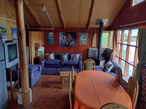 a living room with a couch and a table at Cabañas Don Lino in Cochrane