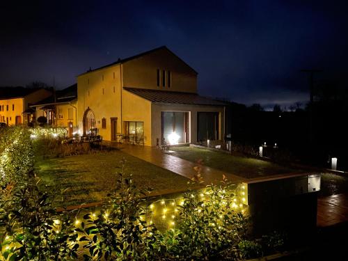 a house with lights in the yard at night at Scheier (Ferienwohnungen) in Perl