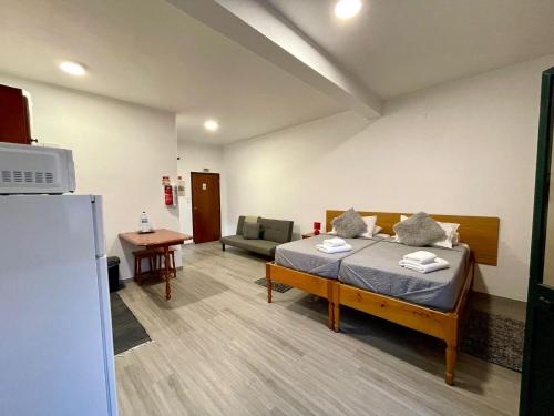 a hospital room with a bed and a chair at Mountain View Star in Estreito da Calheta