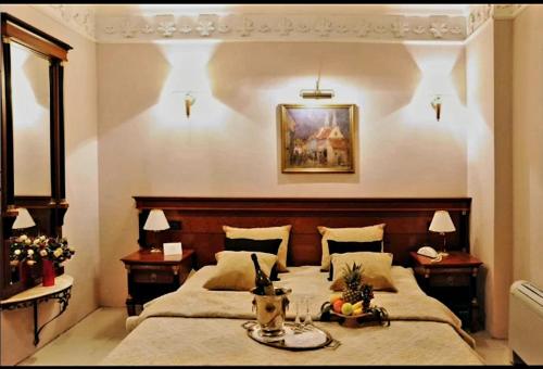 a bedroom with a large bed and two night stands at HOTEL ELSA in Skopje