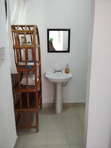 a bathroom with a sink and a mirror at San Miguel 2 in Cozumel