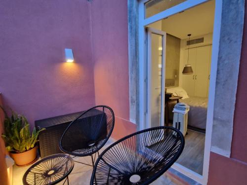 a room with three chairs and a room with a bedroom at Sintra Viscount Apartment - Private Terrace in Sintra