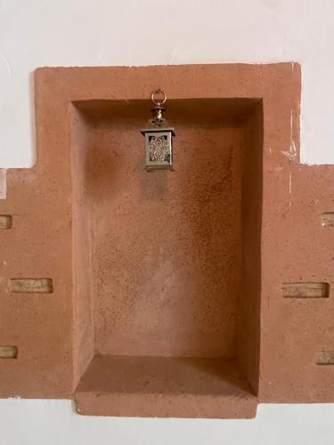 a brown box with a clock on top of it at Tafsut dades guesthouse stay with locals in Tamellalt