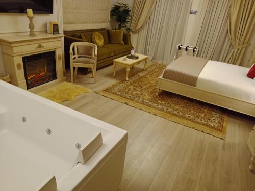 a living room with a bed and a fireplace at Vip Lepanto Castle Suites in Nafpaktos