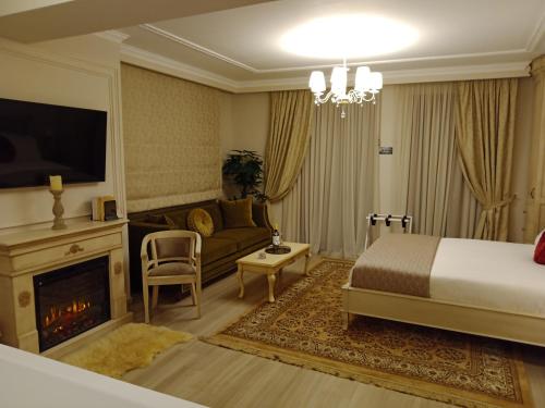 a bedroom with a bed and a couch and a fireplace at Vip Lepanto Castle Suites in Nafpaktos