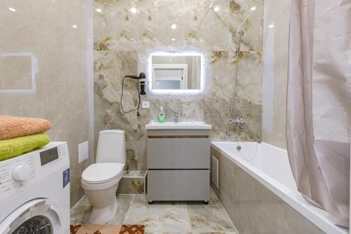 a bathroom with a toilet and a tub and a sink at Apple City Apartments -161, ЭКСПО, Mega Silky Way in Prigorodnyy