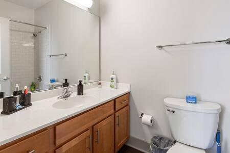 a bathroom with a toilet and a sink and a mirror at Corporate Housing by MGM in Detroit