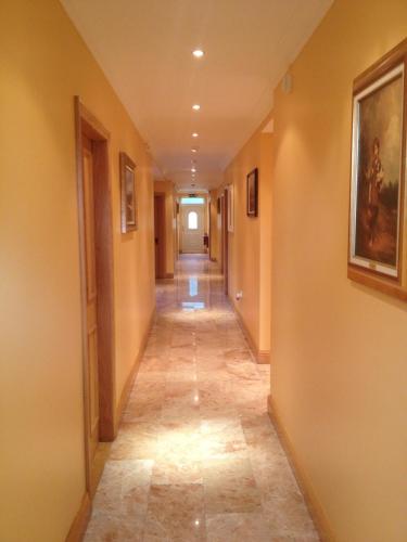 a hallway with a long corridor with a hallway at Anvil House in Achill Sound