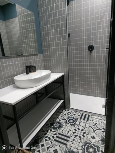 a bathroom with a sink and a shower at Blu room in Taranto