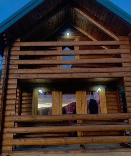 a close up of a wooden house with two windows at Cottages Jasavić in Plav