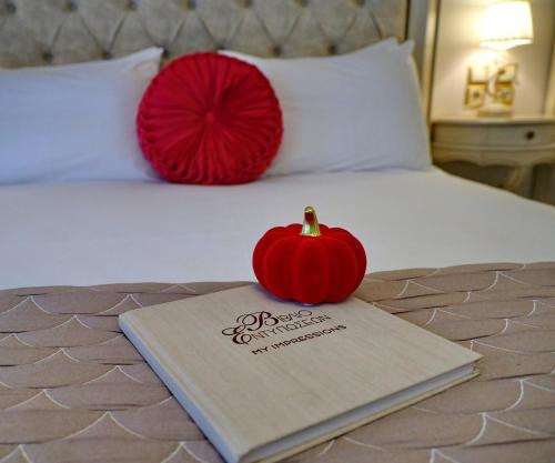 a book with a pumpkin sitting on top of a bed at Vip Lepanto Castle Suites in Nafpaktos
