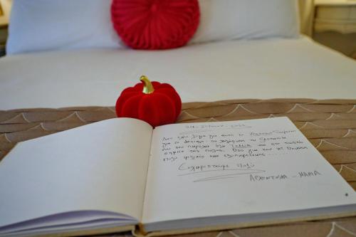 an open book with a pumpkin on a bed at Vip Lepanto Castle Suites in Nafpaktos