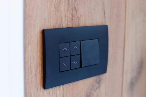 a blue light switch on a wooden wall at GO Jahorina by Olympic Gardens in Jahorina