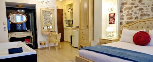 a bedroom with a bed and a bathroom with a sink at Vip Lepanto Port Suites in Nafpaktos