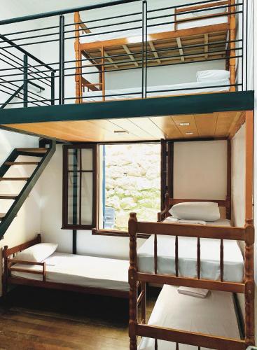 two bunk beds in a room with a window at Hostel Sunrise in Rio de Janeiro