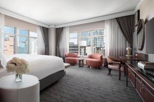 a hotel room with a large bed and a desk at The Ritz-Carlton, Dallas in Dallas