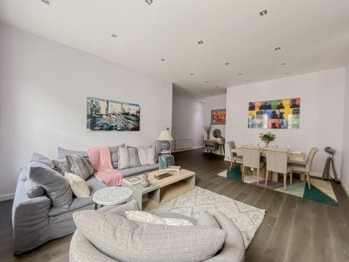 a living room with a couch and a table at Exceptional apartment in the most desirable street in London