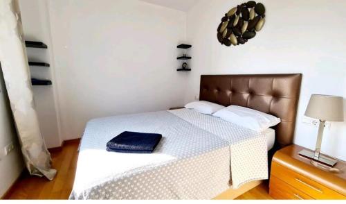 a bedroom with a bed with a blue towel on it at MERCE APARTMENT FORUM BARCELONA in Sant Adria de Besos