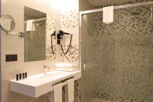 a bathroom with a sink and a shower at Santa Limbania Boutique Hotel in Santa Cruz de la Sierra