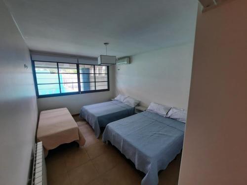 a bedroom with two beds and a window at MODERNA x 11 Pax in Mendoza