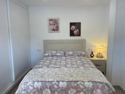 a bedroom with a bed and two pictures on the wall at PEÑISMAR AZAHAR in Peniscola